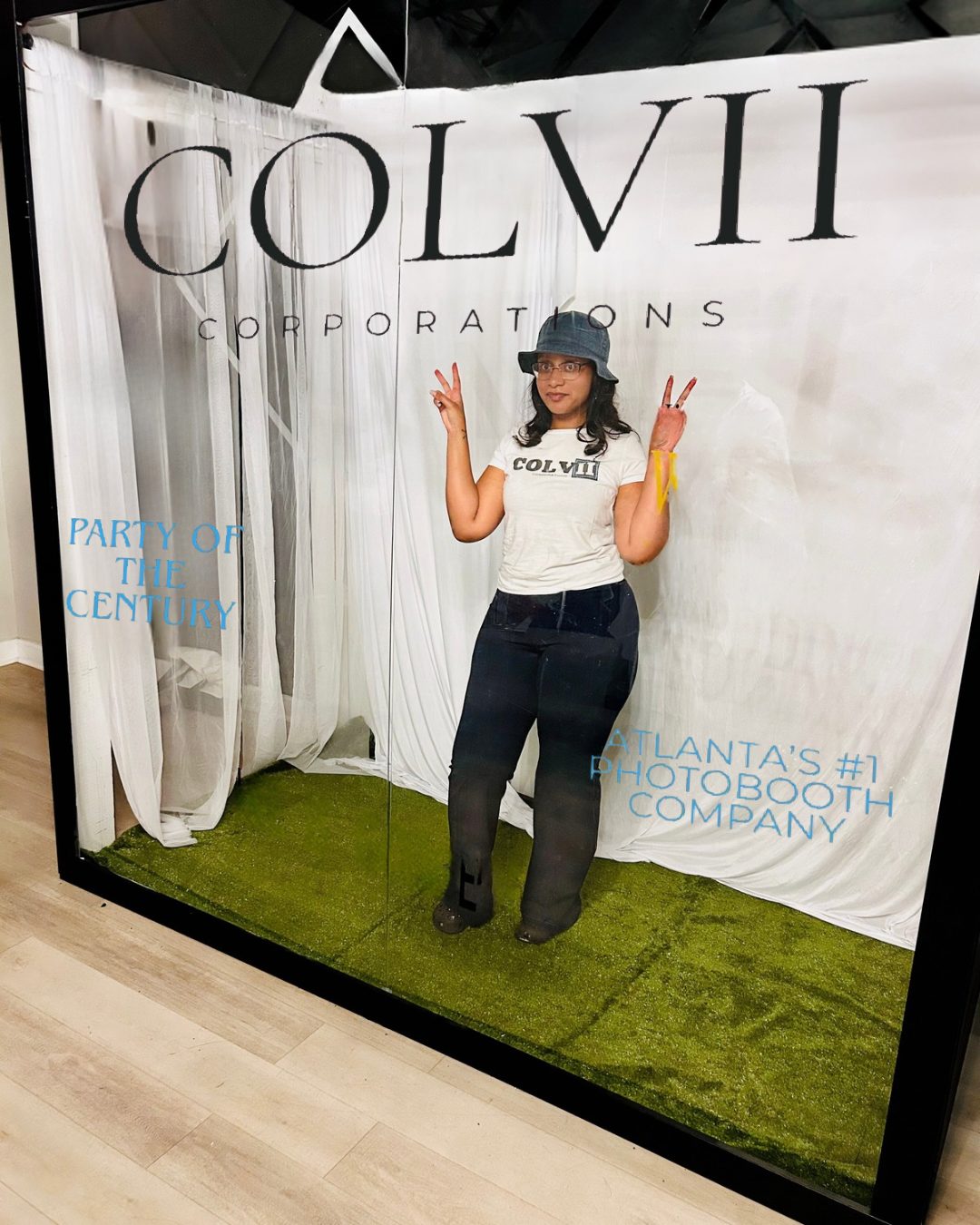 Guest posing in the Colvii magazine-style photo booth backdrop